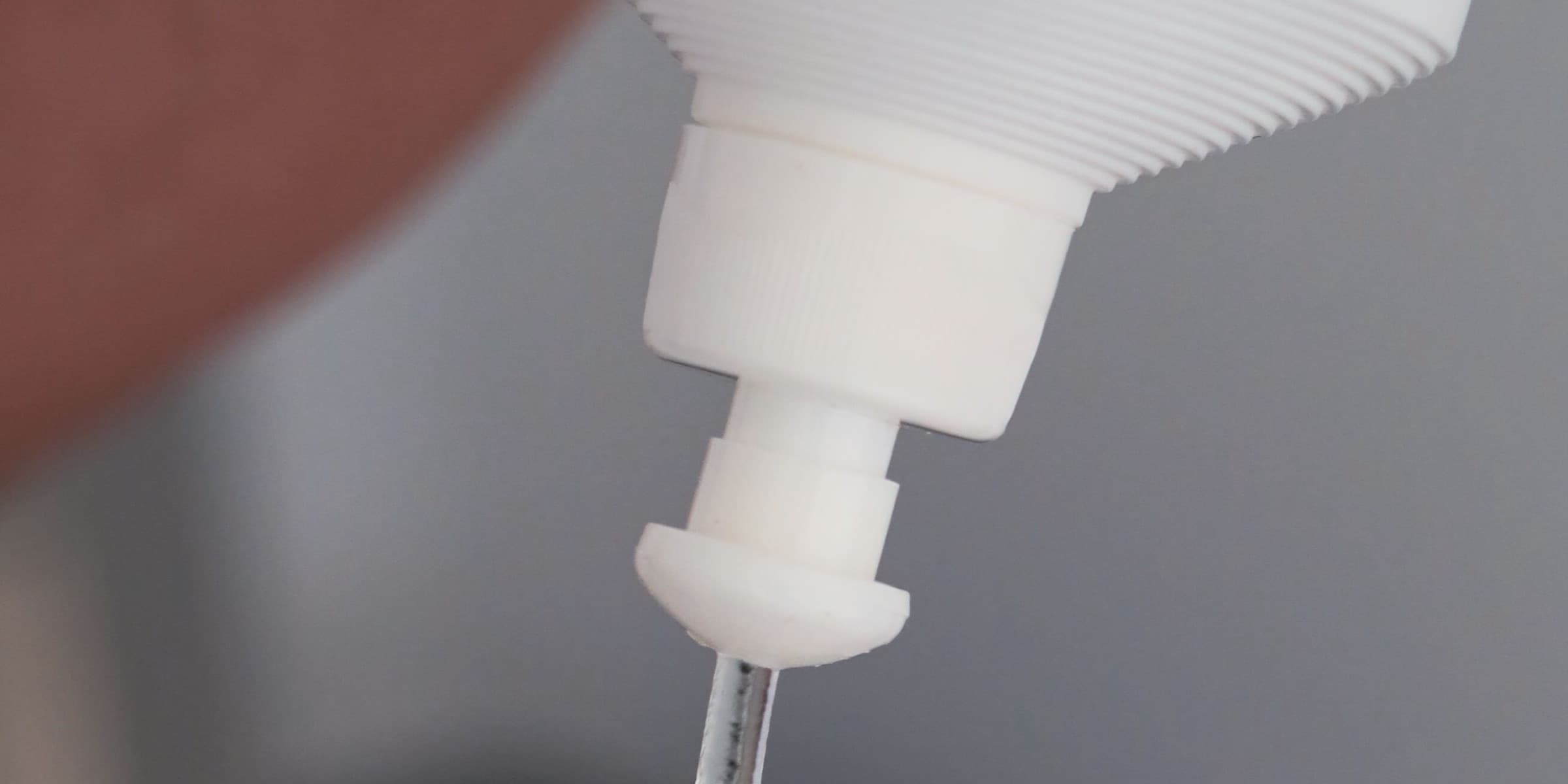 Clear gel poured from a bottle onto a wooden stick
