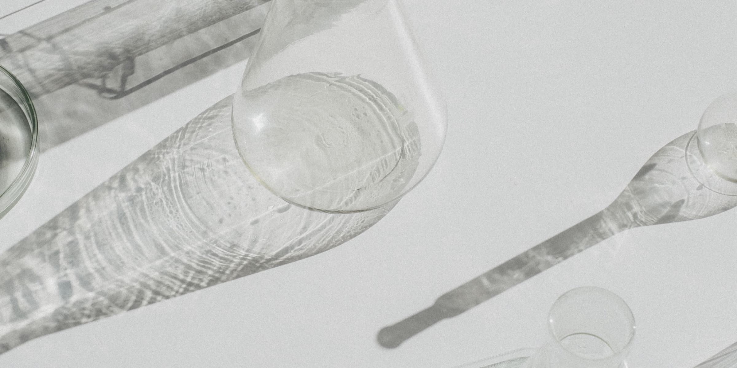 Laboratory glassware casting shadows on white